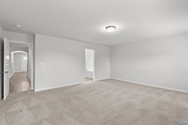 103 Gander Cir, Owens Cross Roads, AL 35763 - empty room featuring arched walkways, light carpet, and a smoke detector