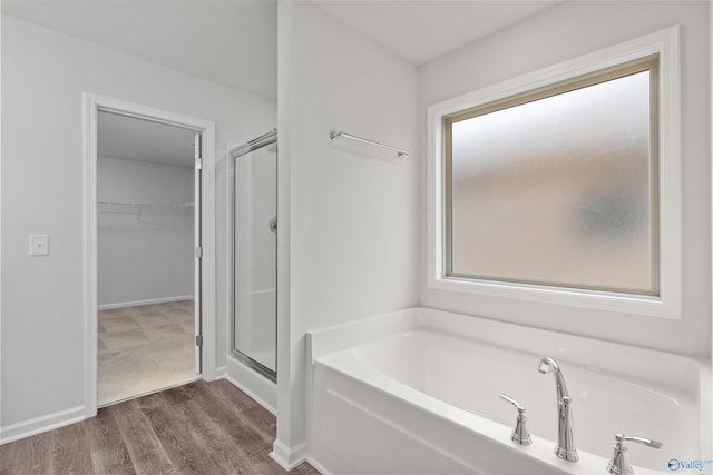 103 Gander Cir, Owens Cross Roads, AL 35763 - full bath with a stall shower, a bath, wood finished floors, and a spacious closet
