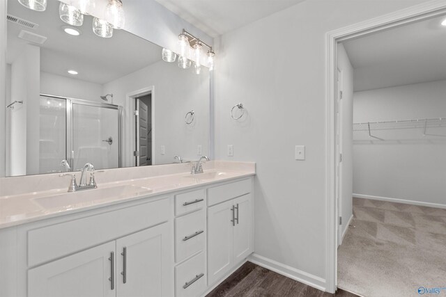 103 Gander Cir, Owens Cross Roads, AL 35763 - bathroom featuring a stall shower, double vanity, and a spacious closet