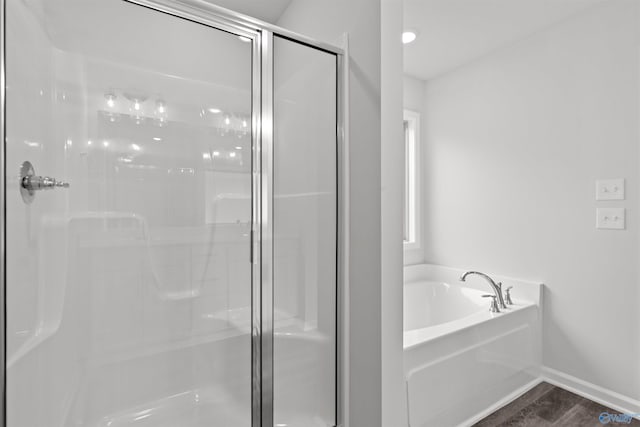 103 Gander Cir, Owens Cross Roads, AL 35763 - full bathroom featuring a shower stall, a garden tub, and wood finished floors