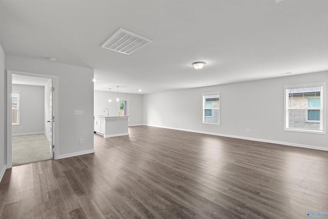 103 Gander Cir, Owens Cross Roads, AL 35763 - unfurnished living room featuring dark wood-type flooring and healthy amount of natural light