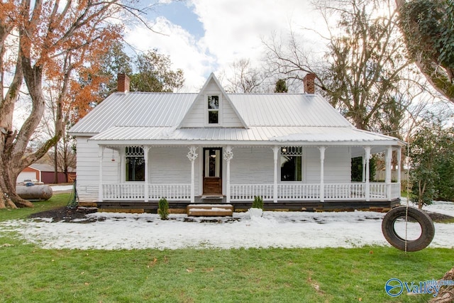 farmhouse with a porch and a yard