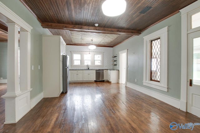 unfurnished living room with dark hardwood / wood-style floors, decorative columns, crown molding, and beam ceiling