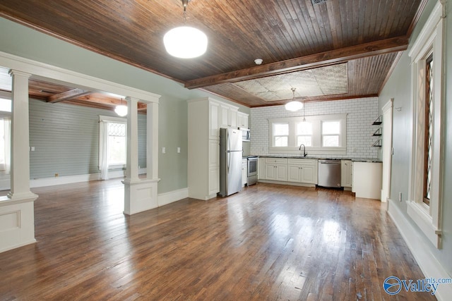 kitchen with white cabinets, stainless steel appliances, a healthy amount of sunlight, and decorative columns