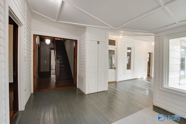 interior space with wooden walls and dark wood-type flooring