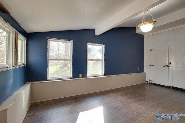 empty room with dark hardwood / wood-style floors and vaulted ceiling with beams