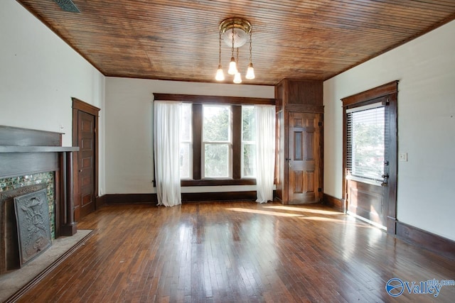 unfurnished living room featuring a tiled fireplace, a notable chandelier, hardwood / wood-style flooring, and wood ceiling