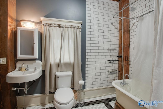 bathroom featuring toilet, walk in shower, tile patterned flooring, and sink