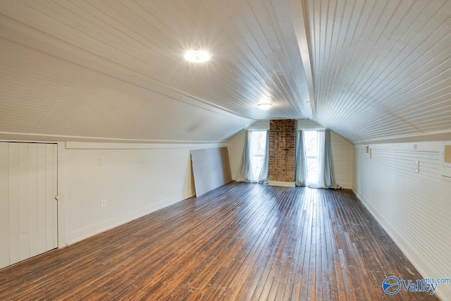 bonus room featuring vaulted ceiling and dark hardwood / wood-style floors