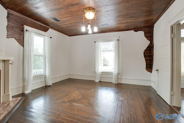 spare room featuring dark parquet flooring, crown molding, wooden ceiling, and a wealth of natural light