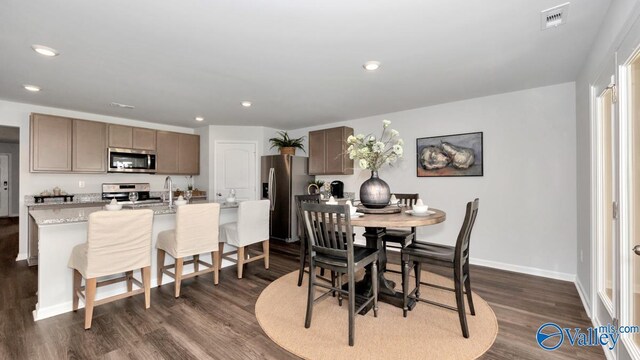 dining room with dark wood-type flooring