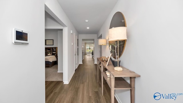 hallway with dark hardwood / wood-style flooring