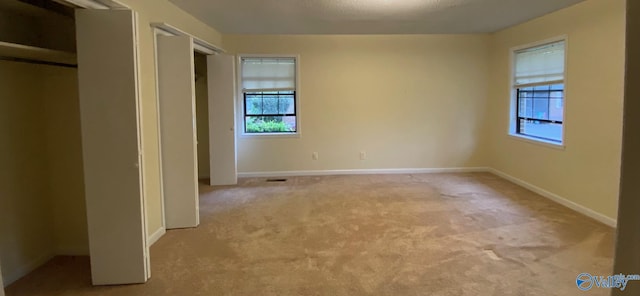 unfurnished bedroom with light carpet and a textured ceiling