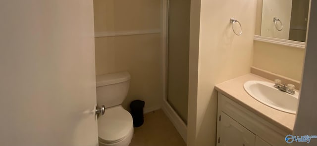 bathroom featuring walk in shower, vanity, and toilet