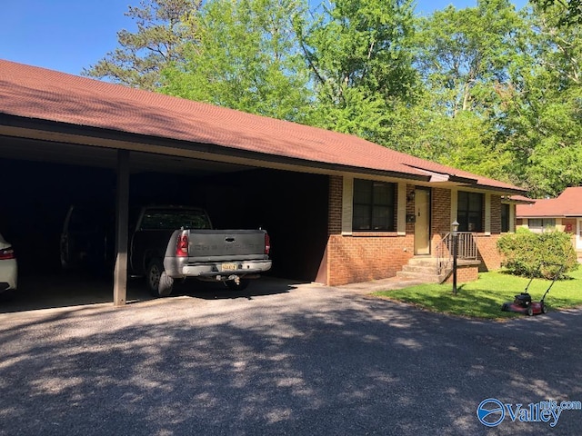 ranch-style home featuring a carport