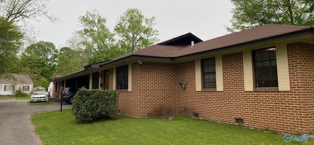 view of side of property with a yard