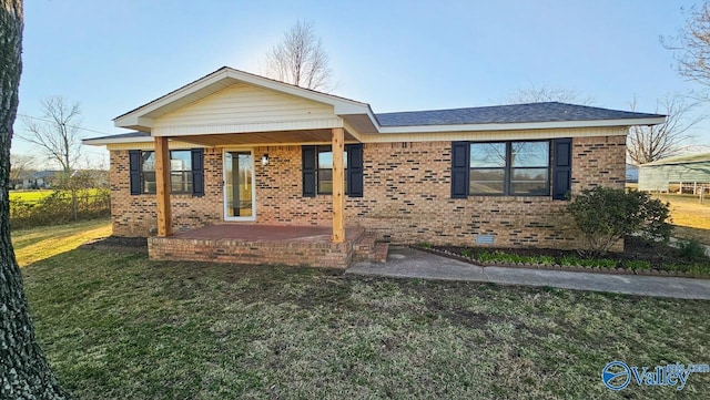 single story home featuring brick siding, fence, a front lawn, and a patio