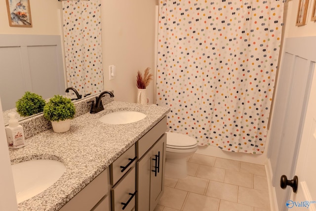 bathroom with tile patterned flooring, vanity, a shower with shower curtain, and toilet