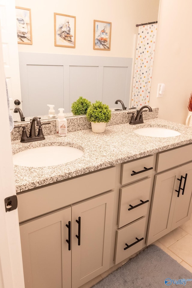 bathroom with tile patterned flooring and vanity