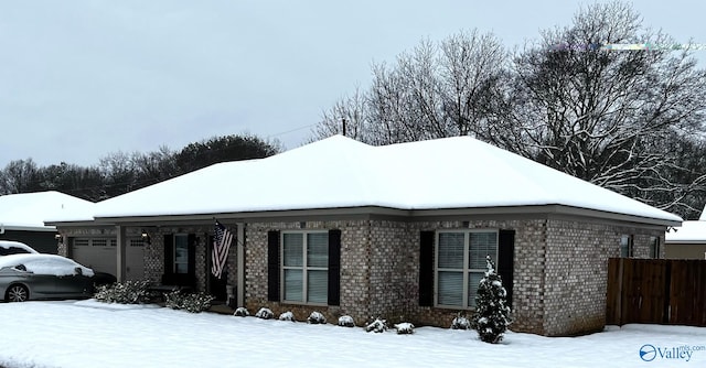 view of snowy exterior with a garage