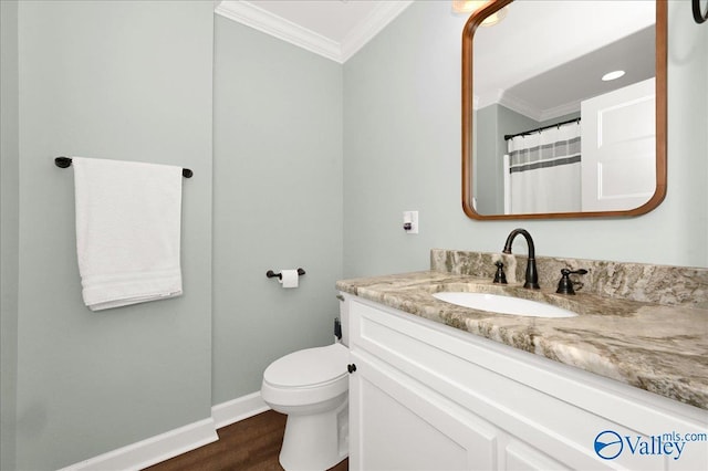 bathroom featuring a shower with shower curtain, hardwood / wood-style floors, toilet, vanity, and crown molding