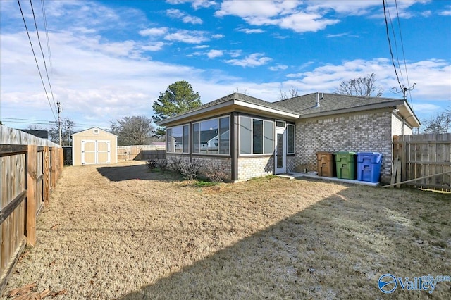 rear view of property with a storage shed