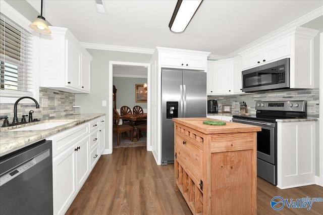 kitchen featuring appliances with stainless steel finishes, white cabinets, and crown molding