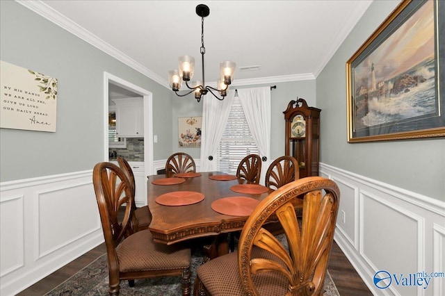 dining space featuring an inviting chandelier and crown molding