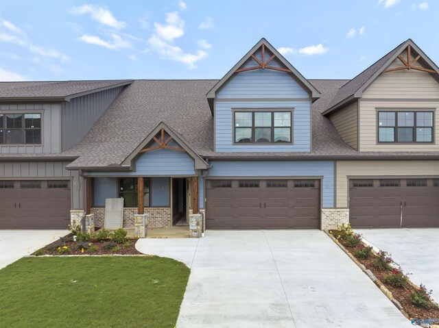 craftsman-style home featuring a garage and a front yard