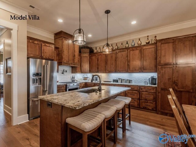 kitchen featuring wood-type flooring, high quality appliances, and tasteful backsplash