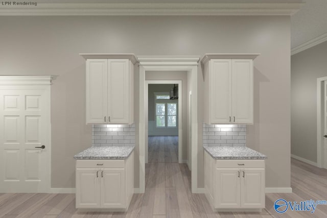 kitchen with white cabinetry, light wood-style floors, and ornamental molding