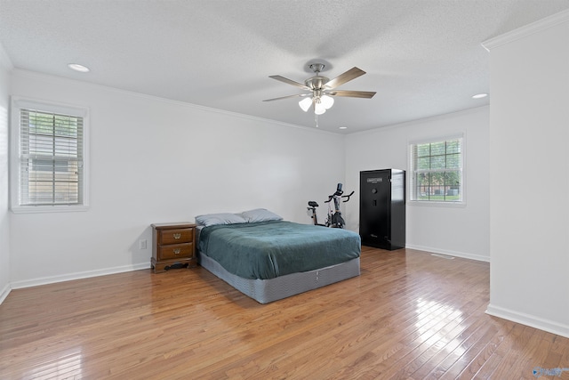 302 Cherry St NW, Hartselle, AL 35640 - bedroom featuring light wood-type flooring, ornamental molding, recessed lighting, a ceiling fan, and a textured ceiling