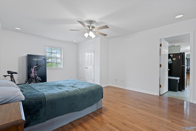 302 Cherry St NW, Hartselle, AL 35640 - bedroom with freestanding refrigerator, light wood finished floors, ornamental molding, a ceiling fan, and recessed lighting
