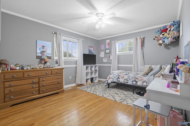 302 Cherry St NW, Hartselle, AL 35640 - bedroom with light wood finished floors, a textured ceiling, crown molding, and a ceiling fan