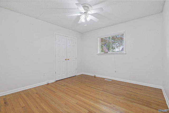 302 Cherry St NW, Hartselle, AL 35640 - unfurnished bedroom featuring light wood-style floors, a closet, and ceiling fan