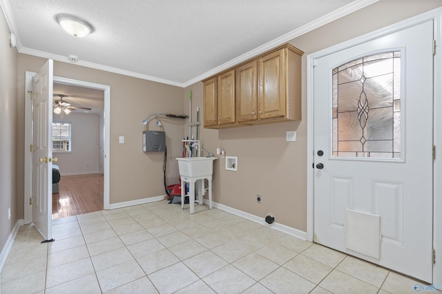 302 Cherry St NW, Hartselle, AL 35640 - laundry area with hookup for a washing machine, cabinet space, hookup for an electric dryer, a textured ceiling, and crown molding