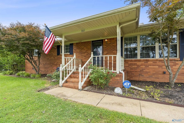 302 Cherry St NW, Hartselle, AL 35640 - view of front facade featuring brick siding and a front yard