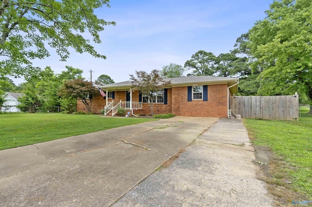302 Cherry St NW, Hartselle, AL 35640 - view of front of house featuring driveway, brick siding, and a porch