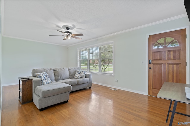 302 Cherry St NW, Hartselle, AL 35640 - living room with a ceiling fan, light wood-type flooring, crown molding, and a textured ceiling
