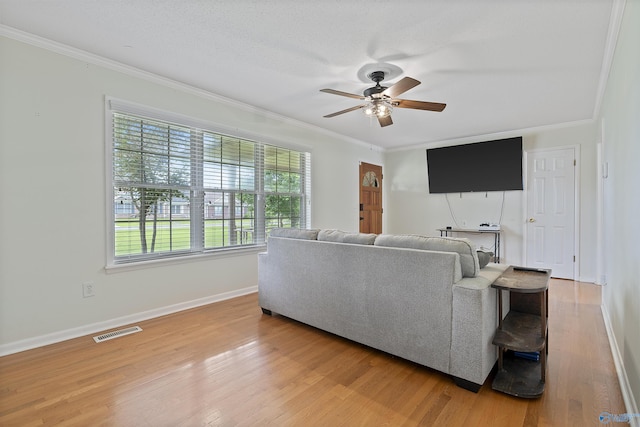 302 Cherry St NW, Hartselle, AL 35640 - living area with crown molding, ceiling fan, and light wood-style flooring