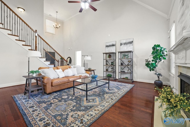 living room with plenty of natural light, crown molding, and a high ceiling