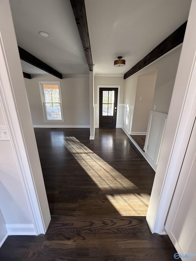 foyer with beamed ceiling and dark wood-type flooring