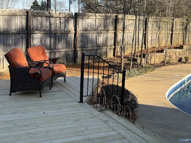 deck featuring a fenced in pool