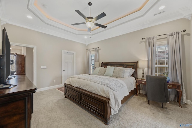 bedroom featuring light carpet, baseboards, visible vents, and a raised ceiling