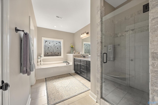 bathroom with a stall shower, visible vents, tile patterned floors, a garden tub, and vanity