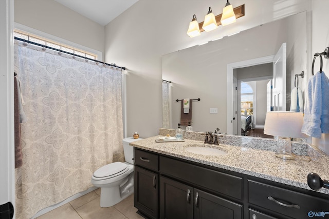 bathroom featuring toilet, vanity, ensuite bath, plenty of natural light, and tile patterned floors