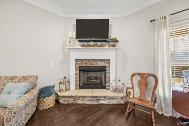 living area with ornamental molding, a fireplace, and wood finished floors