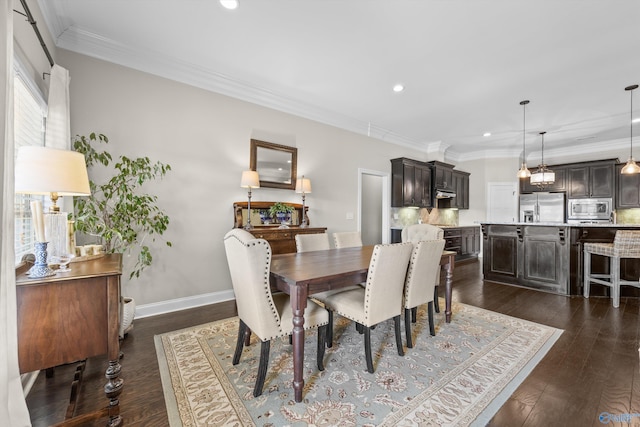 dining area featuring ornamental molding, dark wood-style flooring, and baseboards