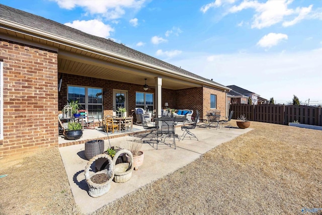 view of patio featuring fence and a ceiling fan