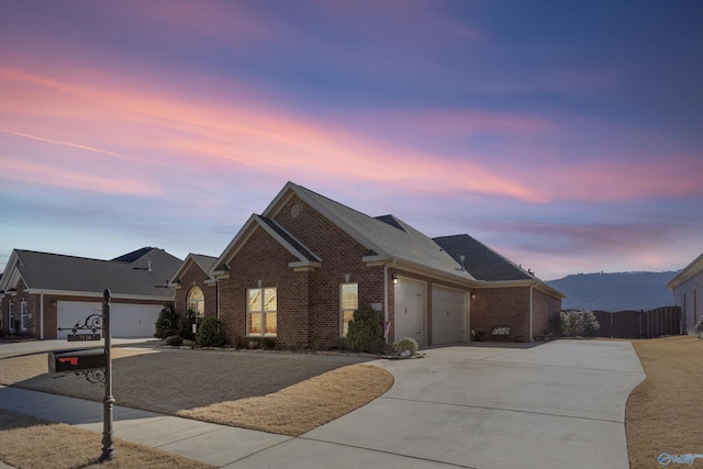 view of front facade with a garage, concrete driveway, and brick siding